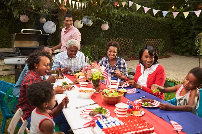 Family at the table for Fourth of July barbecue.