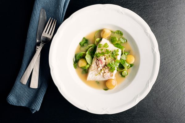 An overhead view of a plate of fish beurre blanc
