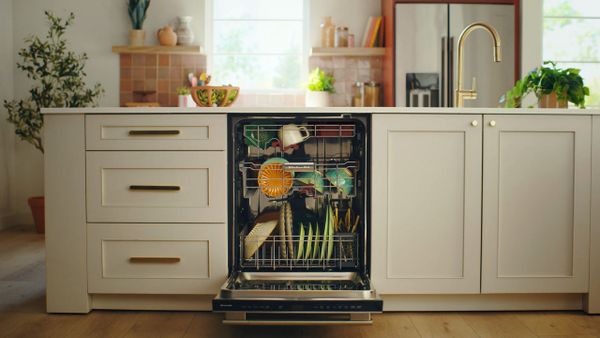 Credit: KitchenAid An open KitchenAid KDTS434SPS dishwasher with dishes