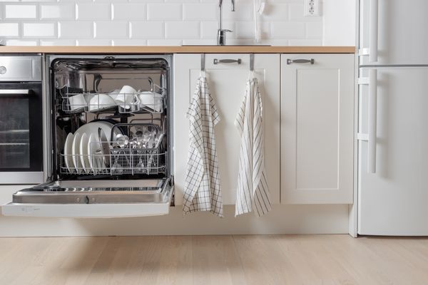 An open dishwasher in a kitchen 