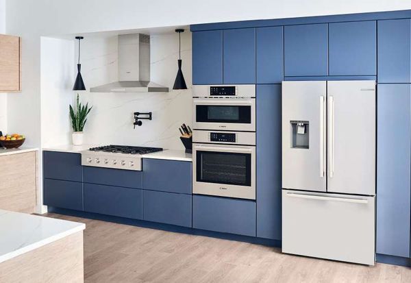 A modern blue kitchen featuring Bosch appliances