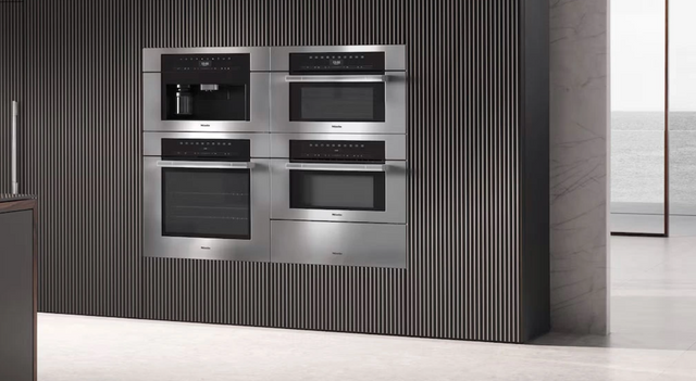 Front view of a wall of Miele wall ovens in a luxury kitchen