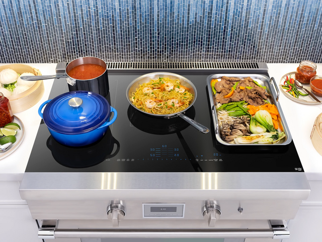 Credit: BSH Group, Thermador | Front view of a Thermador induction range with various pans and foods cooking on top.