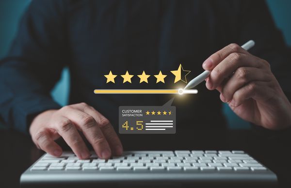 A graphic of a person leaving a digital customer satisfaction rating 