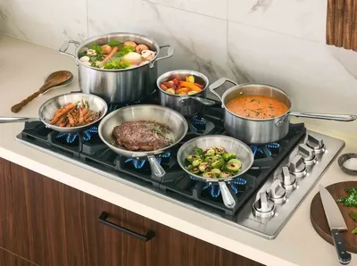 The BlueStar BSDCTX8366B cooktop with cookware and various menu items 