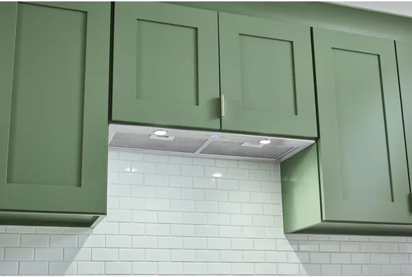 The Broan BBN3306SS range hood installed in green cabinets 