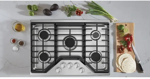 The Cafe CGP70302NS1 cooktop with ingredients 