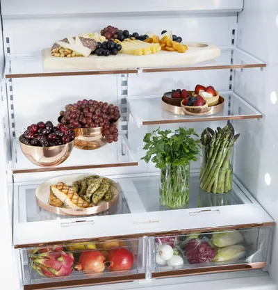 The Cafe CIC36RP2VS1 refrigerator interior with various food items 