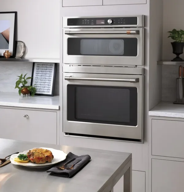 The Cafe CTC912P2NS1 combo wall oven in a kitchen 