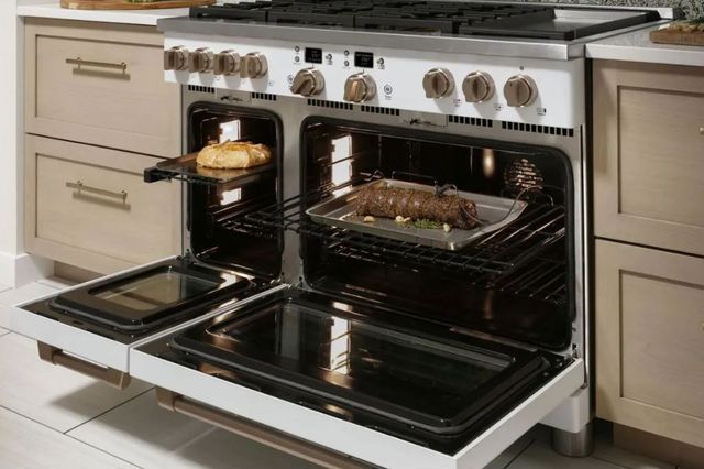 view of an opened dual fuel range with food cooking inside