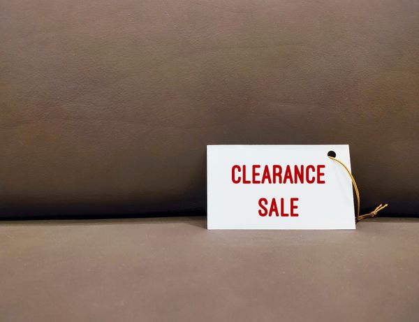 A clearance sale tag against a brown background 