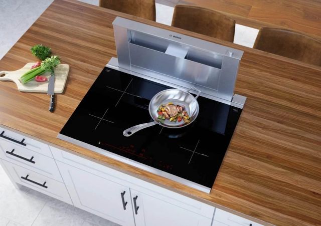 top view of a bosch induction cooktop built into a wood countertop