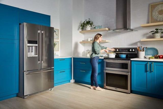front view of a woman cooking on a double oven electric stove