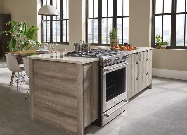 angled view of a modern kitchen island with a dual duel range installed 