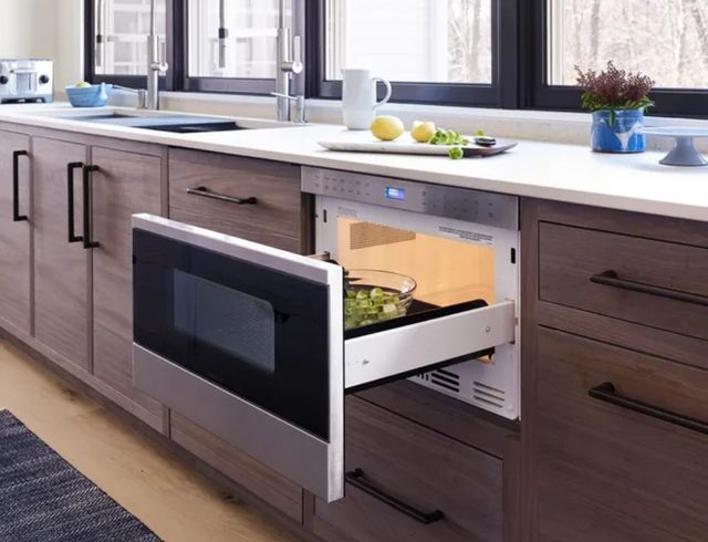 front view of a modern kitchen with a microwave drawer pulled out