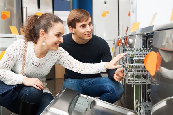 A couple looking at a dishwasher