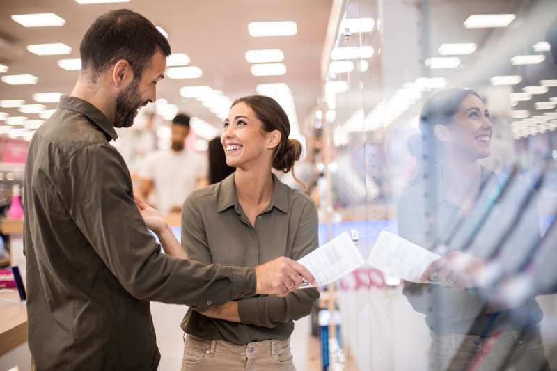 Front view of a man and woman chatting in an appliance store