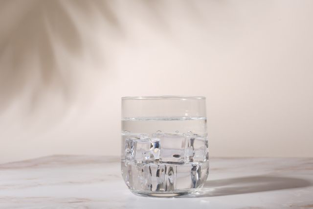 Front view of a glass of ice water with clear ice
