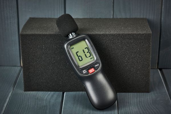 A digital decibel reader on a foam block 