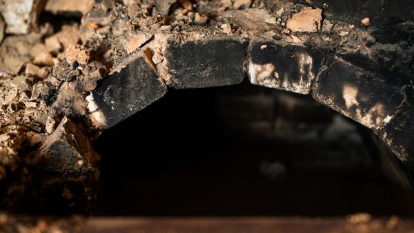 A close-up of a dirty brick oven 