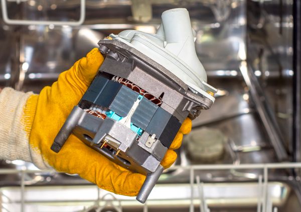 A close-up of a dishwasher water pump
