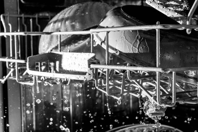 Close view of dishes being cleaned inside a dishwasher