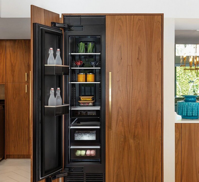 A midcentury modern kitchen featuring wood paneled JennAir® Column Refrigeration.