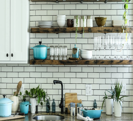 A close-up of a white subway tile kitchen with open shelving." title="A close-up of a white subway tile kitchen with open shelving