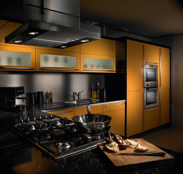 A high-end kitchen with yellow and black appliances 