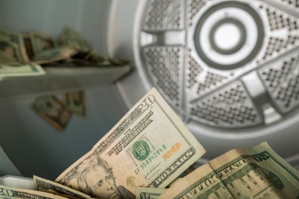A close-up of $20 bills inside of a dryer