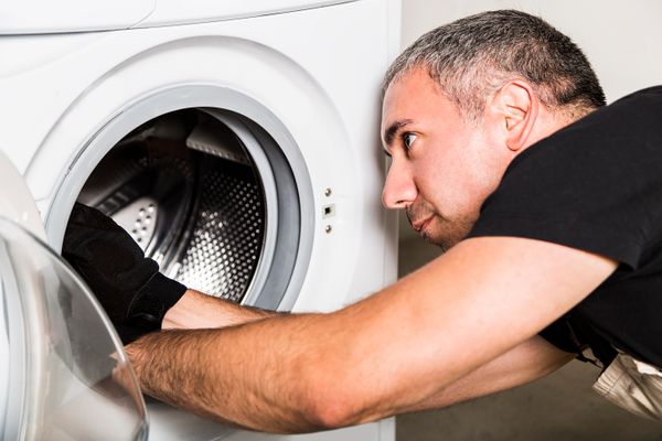 A dryer technician inspecting a dryer 