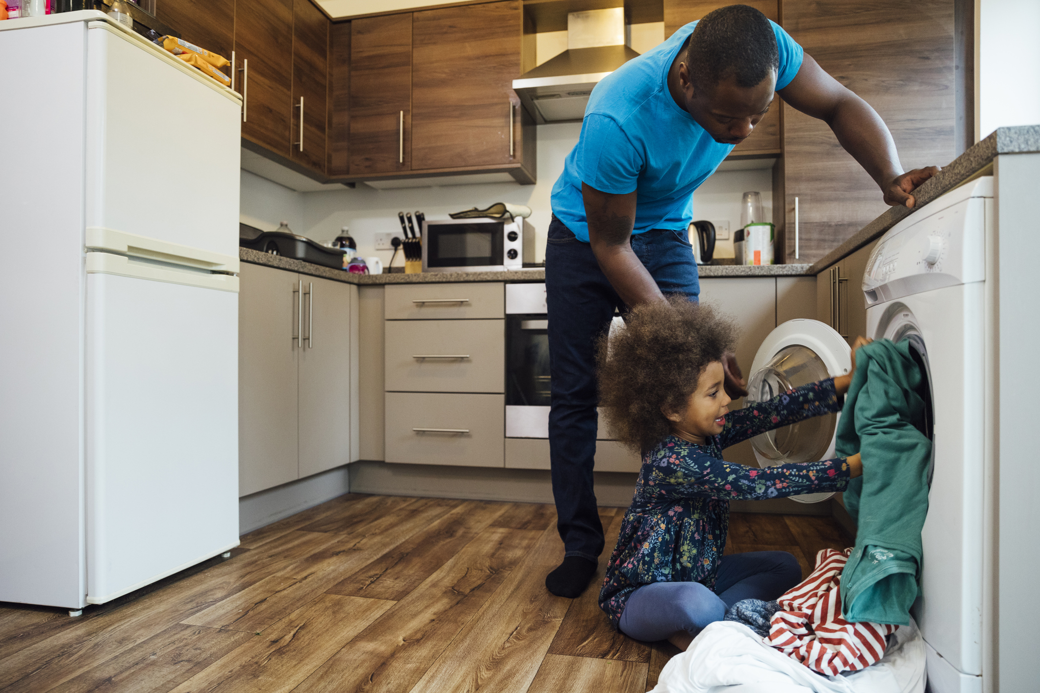 dad and daughter loading washer