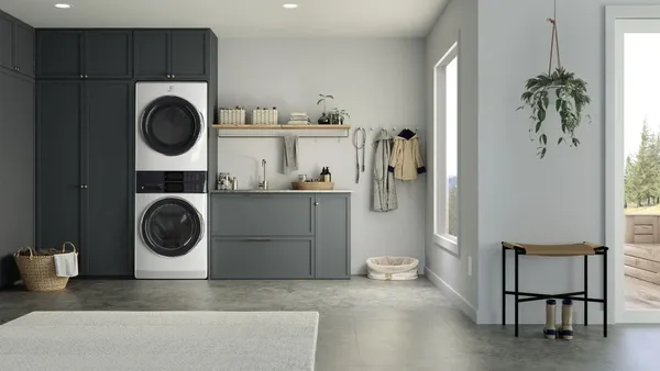 The Electrolux 600 Series ELTE7600AW stacked washer featured in a laundry room 