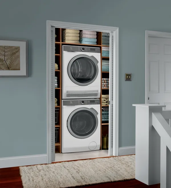 The Electrolux ELFE4222AW dryer and washer in a closet 