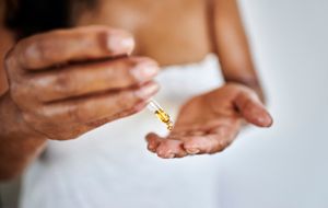 A person dispensing serum onto their hand 