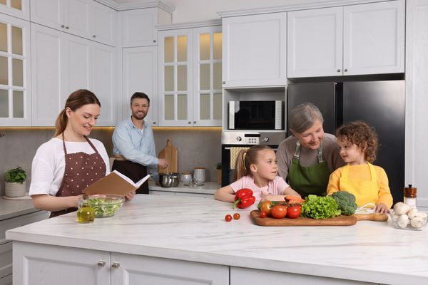 A family prepping vegetables in a kitchen 