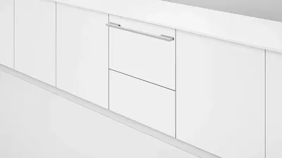 The Fisher & Paykel DD24SI9 N dish drawer in a white finish installed into white cabinetry 