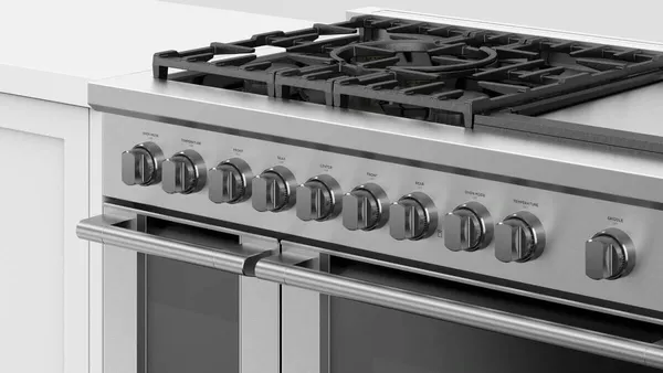 A person igniting the Fisher & Paykel RGV3-485GD-L range 