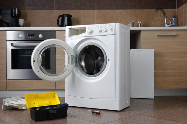 A toolbox and a front load washer in a kitchen 