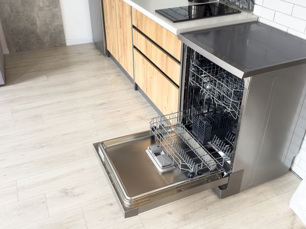 A freestanding stainless steel dishwasher in a kitchen 