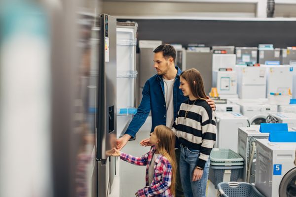 A man, woman, and child French door refrigerator shopping