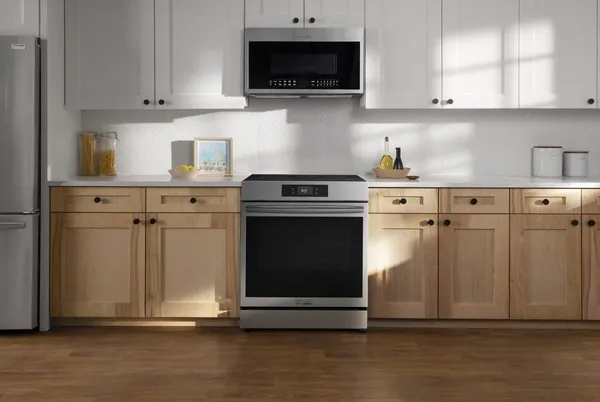 The Frigidaire Gallery GCFI3060BF range with a matching microwave in a kitchen 