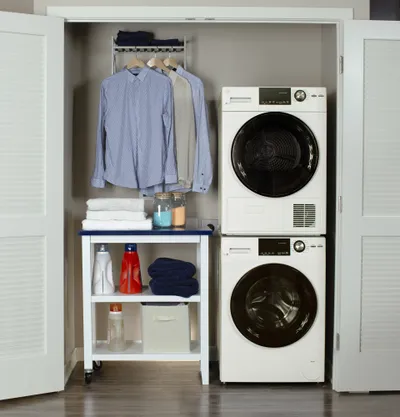 The GE GFT14ESSMWW dryer and washer in a closet 