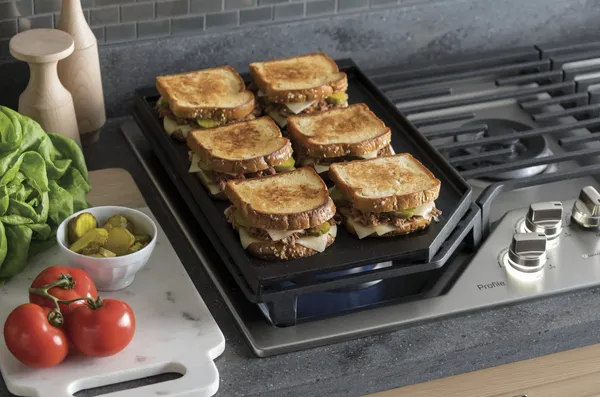 A close-up of grilled cheese cooking on the GE Profile PGP7030SLSS cooktop 