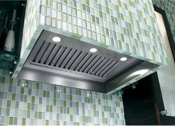 The GE Profile UVC9300SLSS against green and blue kitchen tile 