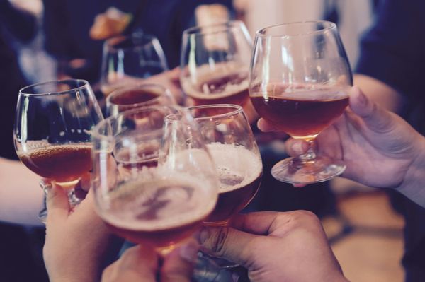 Group Cheering with Drinks at a Party