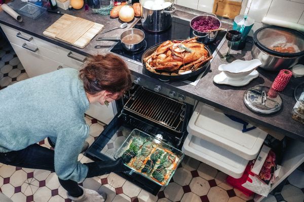 iStock Credit: golero Overhead view of a woman cooking several items in an oven