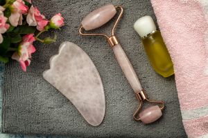 An overhead look at a jade roller and gua sha