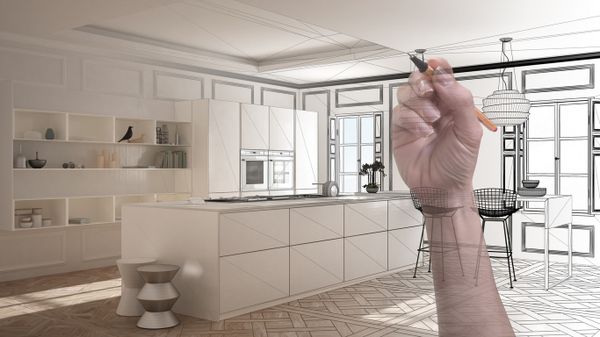 A hand drawing remodel plans on a graphic overlay of a kitchen 