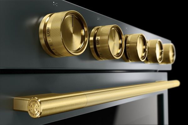 A close-up of a KitchenAid Juniper and Brass range